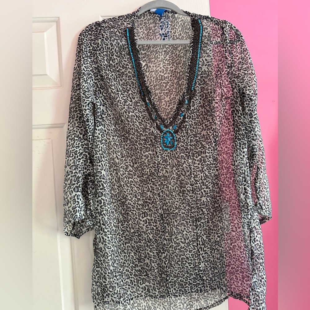 Tag on animal print, with turquoise like embellishment, coverup.